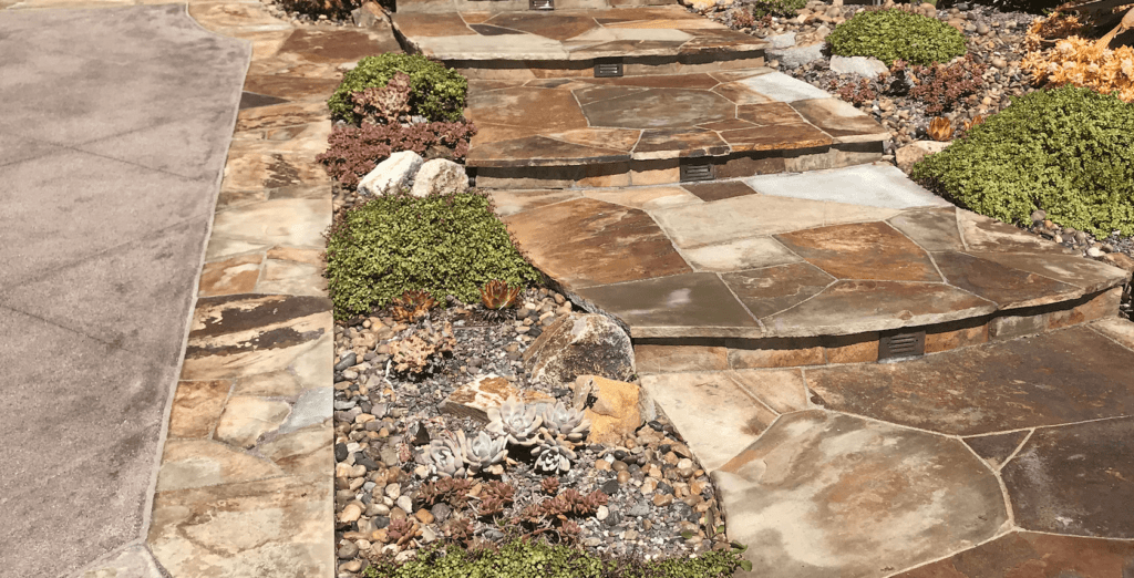 decorative colored concrete driveway stone border stone inlaid steps drought tolerant landscaping